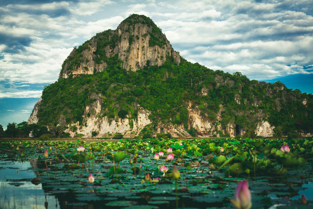 Photo of Green Rocky Mountain under a cloudy sky in Thailand, 