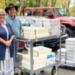 Photo of GeorGene Nelson and Harold Wright of the Klamath Nation's Language Program delivering materials to be digitized