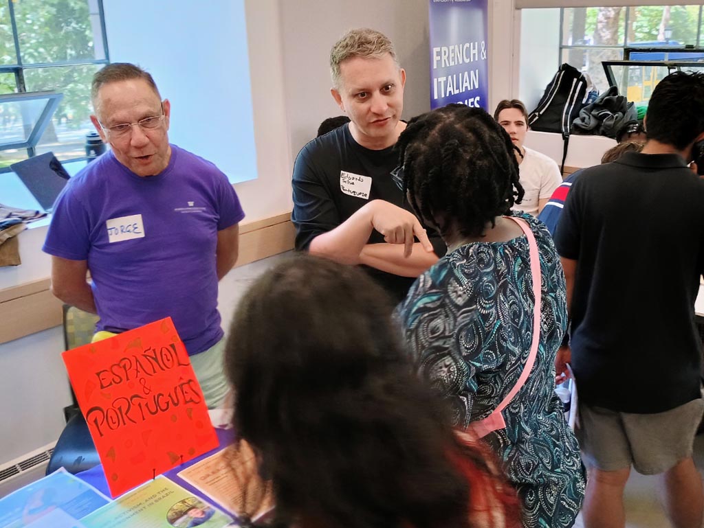 Instructors for the Spanish and Portuguese table speaking with visitors